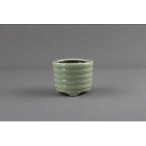 61 - A Longquan Celadon Tripod Incense Burner, Song/Yuan dynasty raised on three ruyi-feet, the exterior ... 