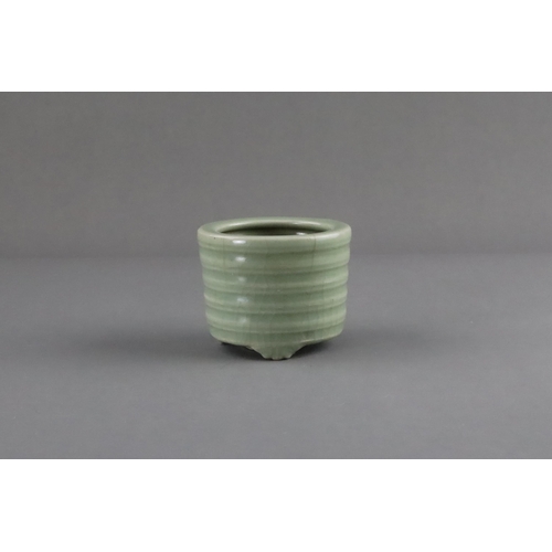 61 - A Longquan Celadon Tripod Incense Burner, Song/Yuan dynasty raised on three ruyi-feet, the exterior ... 