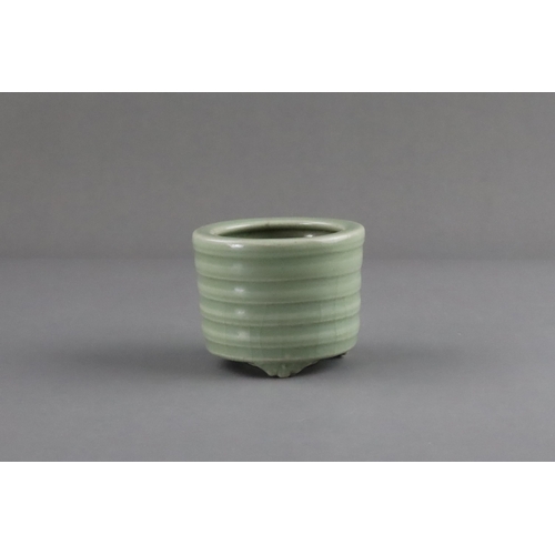 61 - A Longquan Celadon Tripod Incense Burner, Song/Yuan dynasty raised on three ruyi-feet, the exterior ... 