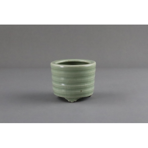 61 - A Longquan Celadon Tripod Incense Burner, Song/Yuan dynasty raised on three ruyi-feet, the exterior ... 