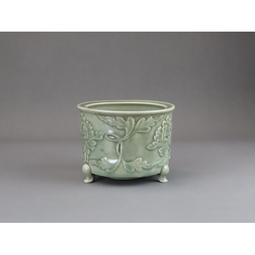 62 - A Longquan Celadon Peony Tripod Censer, early Ming dynasty,   the cylindrical vessel with applied pe... 