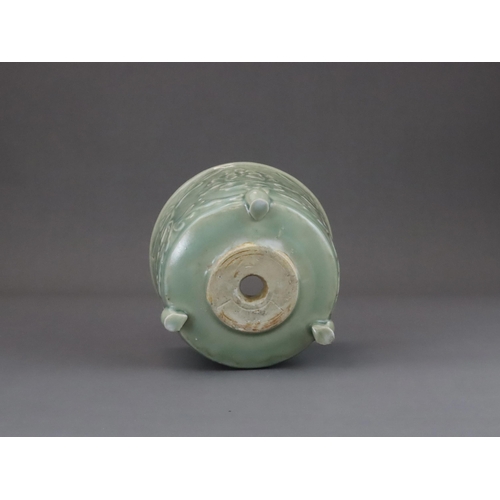 62 - A Longquan Celadon Peony Tripod Censer, early Ming dynasty,   the cylindrical vessel with applied pe... 