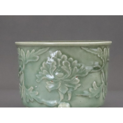 62 - A Longquan Celadon Peony Tripod Censer, early Ming dynasty,   the cylindrical vessel with applied pe... 