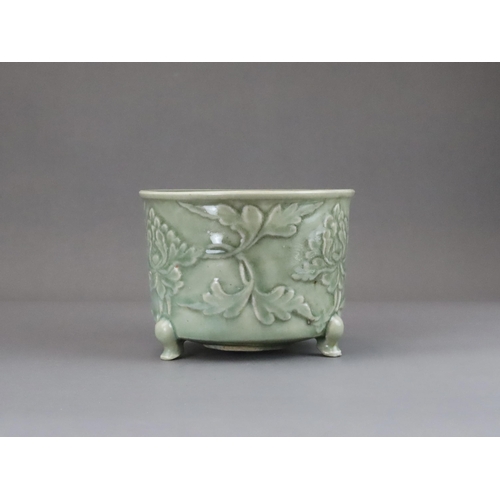 62 - A Longquan Celadon Peony Tripod Censer, early Ming dynasty,   the cylindrical vessel with applied pe... 