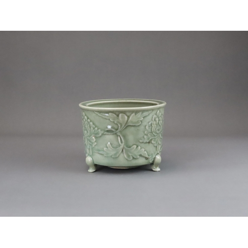 62 - A Longquan Celadon Peony Tripod Censer, early Ming dynasty,   the cylindrical vessel with applied pe... 