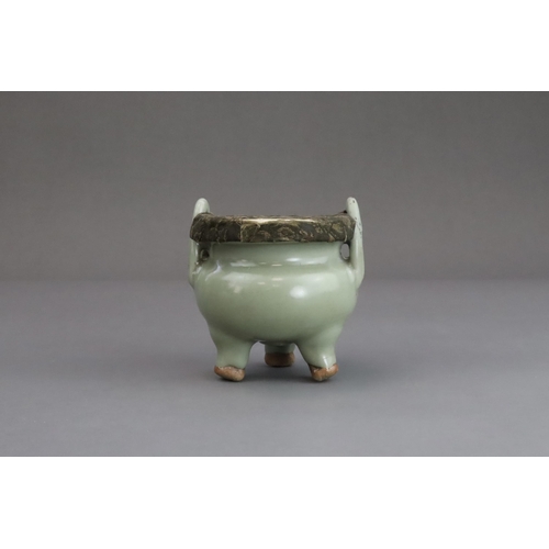 63 - A Longquan Celadon Tripod Incense Burner, Yuan dynasty  the compressed globular body rising from thr... 