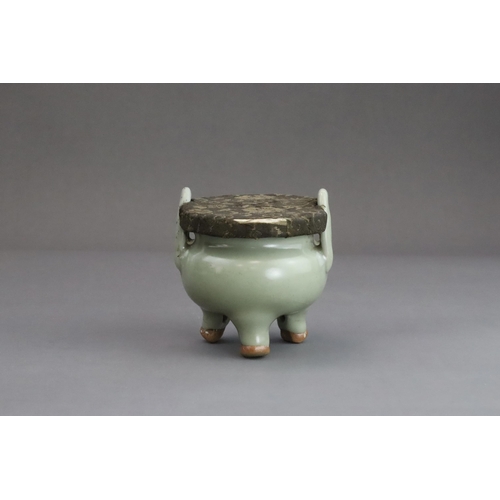 63 - A Longquan Celadon Tripod Incense Burner, Yuan dynasty  the compressed globular body rising from thr... 