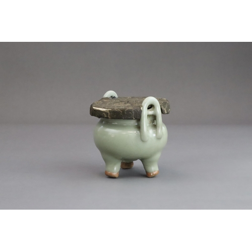 63 - A Longquan Celadon Tripod Incense Burner, Yuan dynasty  the compressed globular body rising from thr... 