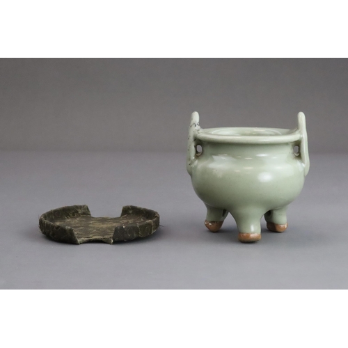 63 - A Longquan Celadon Tripod Incense Burner, Yuan dynasty  the compressed globular body rising from thr... 