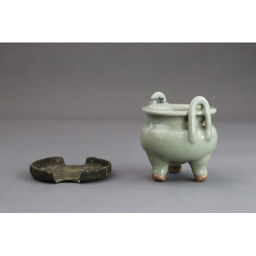 63 - A Longquan Celadon Tripod Incense Burner, Yuan dynasty  the compressed globular body rising from thr... 