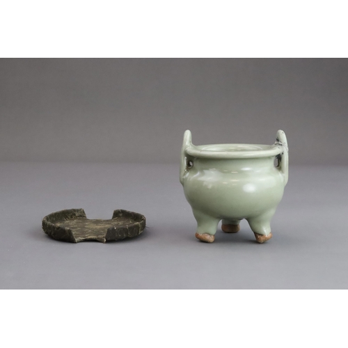 63 - A Longquan Celadon Tripod Incense Burner, Yuan dynasty  the compressed globular body rising from thr... 