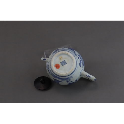 72 - A Blue and White Figural Teapot and wood cover, Chongzhen  painted in soft tones on the globular sid... 