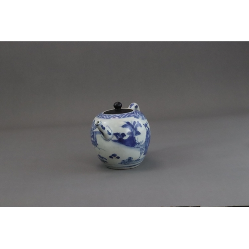 72 - A Blue and White Figural Teapot and wood cover, Chongzhen  painted in soft tones on the globular sid... 