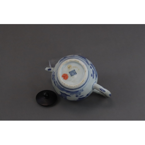 72 - A Blue and White Figural Teapot and wood cover, Chongzhen  painted in soft tones on the globular sid... 