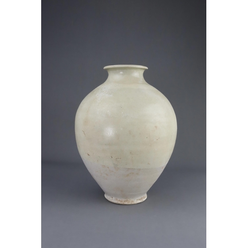 8 - A White-glazed Jar, Tang dynasty the finely potted oviform jar with short neck and rounded rim, cove... 