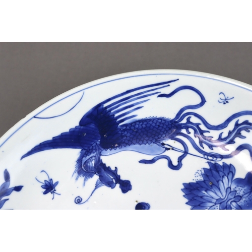 82 - A Blue and White 'Peony and Phoenix' Dish, Kangxi of rounded shape from the short tapering foot to t... 