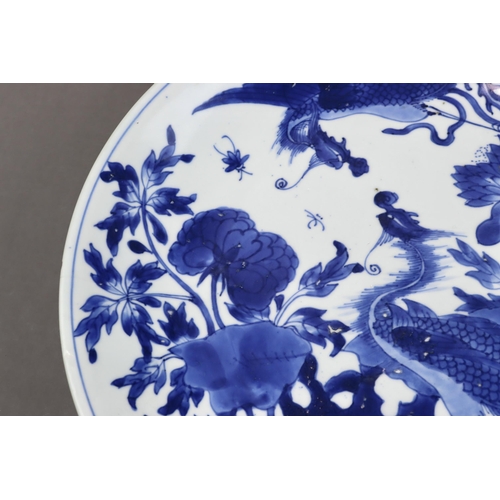 82 - A Blue and White 'Peony and Phoenix' Dish, Kangxi of rounded shape from the short tapering foot to t... 