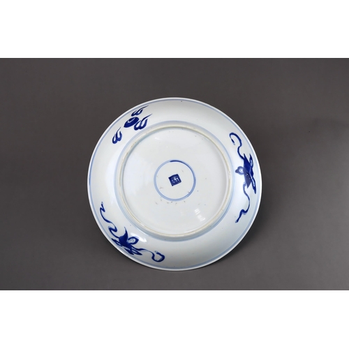 82 - A Blue and White 'Peony and Phoenix' Dish, Kangxi of rounded shape from the short tapering foot to t... 