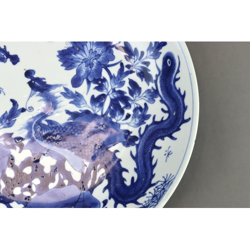 82 - A Blue and White 'Peony and Phoenix' Dish, Kangxi of rounded shape from the short tapering foot to t... 