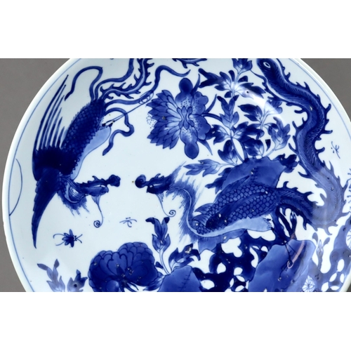 82 - A Blue and White 'Peony and Phoenix' Dish, Kangxi of rounded shape from the short tapering foot to t... 