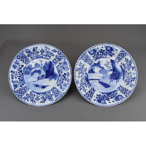 83 - A Pair of Blue and White Dishes with Landscapes, Kangxi, each with a central medallion of a rustic h... 