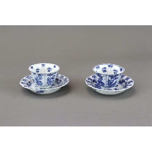 85 - Blue and White: Two Cups and Two Saucers, Kangxi the barbed moulded cups with panelled bird and flow... 