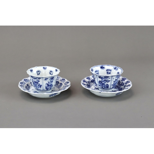 85 - Blue and White: Two Cups and Two Saucers, Kangxi the barbed moulded cups with panelled bird and flow... 