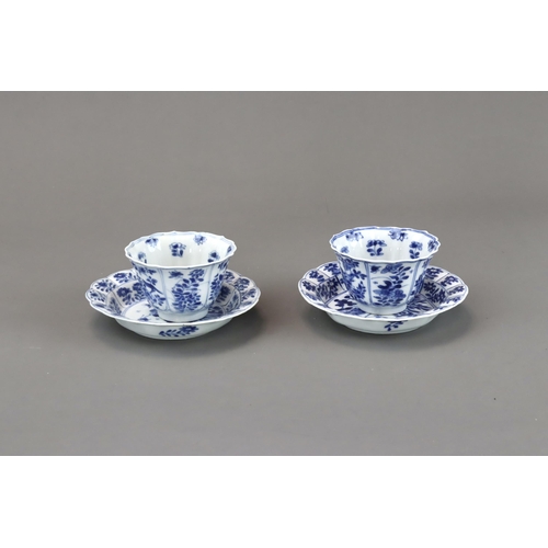 85 - Blue and White: Two Cups and Two Saucers, Kangxi the barbed moulded cups with panelled bird and flow... 