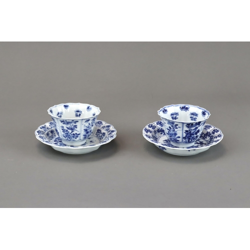 85 - Blue and White: Two Cups and Two Saucers, Kangxi the barbed moulded cups with panelled bird and flow... 