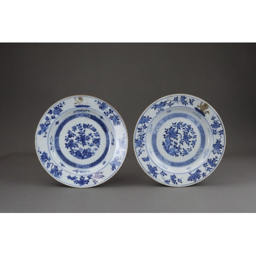 86 - A Pair of  Blue and White Armorial  Floral Plates, Kangxi with peony and rocks painted in blue and w... 