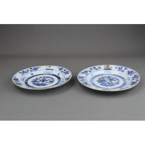 86 - A Pair of  Blue and White Armorial  Floral Plates, Kangxi with peony and rocks painted in blue and w... 