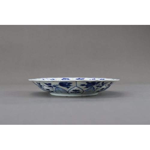 89 - A Blue and White Figural Dish, Kangxi moulded in floral shape, painted in blue and white with a lady... 