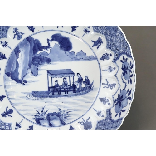 91 - A Blue and White 'Red Cliff' Dish, Kangxi, well painted in good blue with a central scene of boating... 