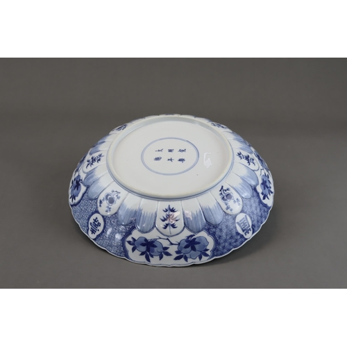 91 - A Blue and White 'Red Cliff' Dish, Kangxi, well painted in good blue with a central scene of boating... 