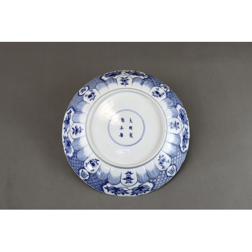 91 - A Blue and White 'Red Cliff' Dish, Kangxi, well painted in good blue with a central scene of boating... 