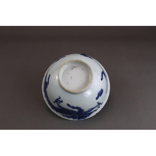 95 - A Blue and White Dragon Bowl, early 18th century, painted in strong blue with a vigorous four clawed... 