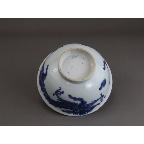 95 - A Blue and White Dragon Bowl, early 18th century, painted in strong blue with a vigorous four clawed... 