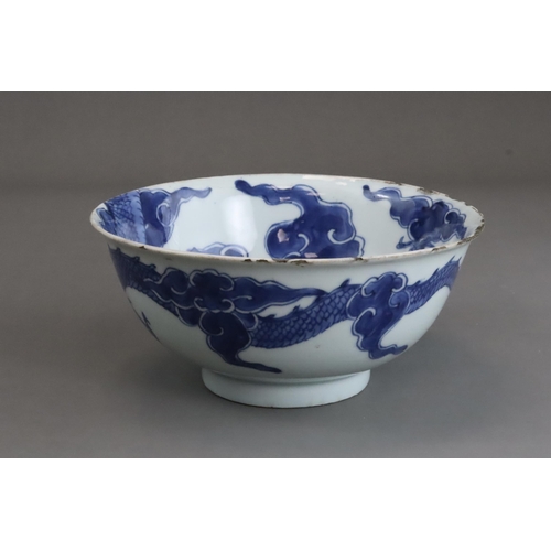 95 - A Blue and White Dragon Bowl, early 18th century, painted in strong blue with a vigorous four clawed... 