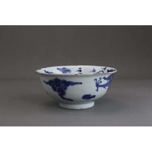 95 - A Blue and White Dragon Bowl, early 18th century, painted in strong blue with a vigorous four clawed... 