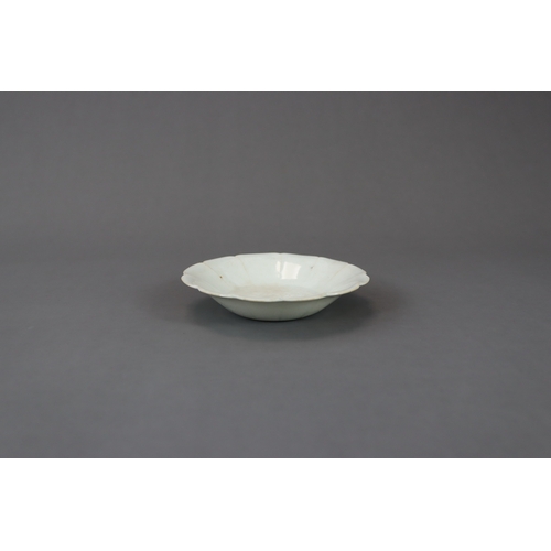 34 - A Qingbai Petal Lobed Dish, Song dynasty with rounded sides rising from a flat base to a gently flar... 