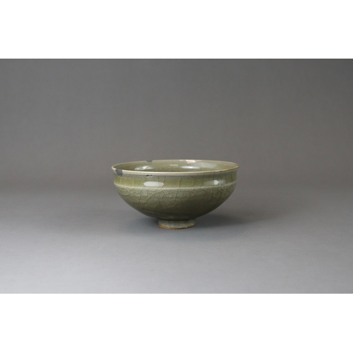 41 - A Longquan Celadon Cup, Song dynasty potted with rounded sides rising from a narrow foot to a softly... 