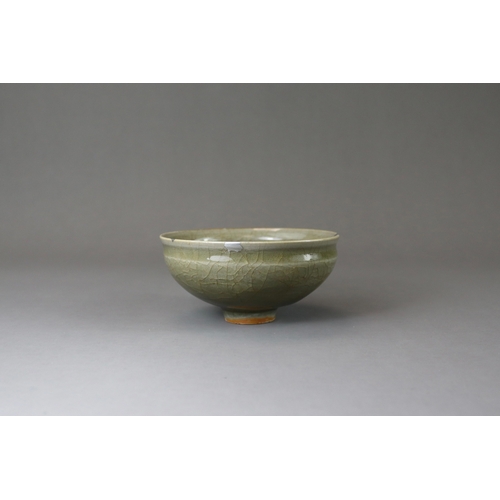 41 - A Longquan Celadon Cup, Song dynasty potted with rounded sides rising from a narrow foot to a softly... 