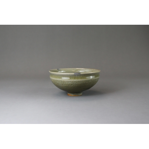 41 - A Longquan Celadon Cup, Song dynasty potted with rounded sides rising from a narrow foot to a softly... 