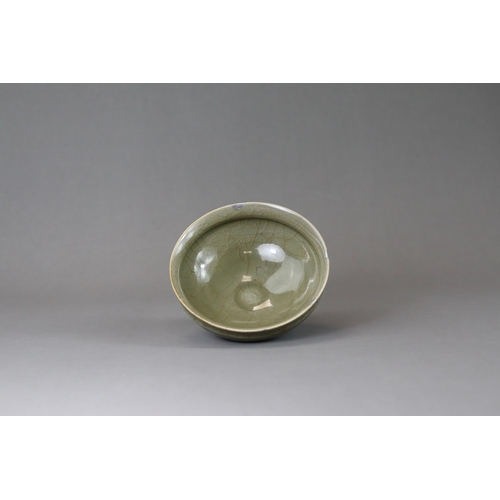 41 - A Longquan Celadon Cup, Song dynasty potted with rounded sides rising from a narrow foot to a softly... 