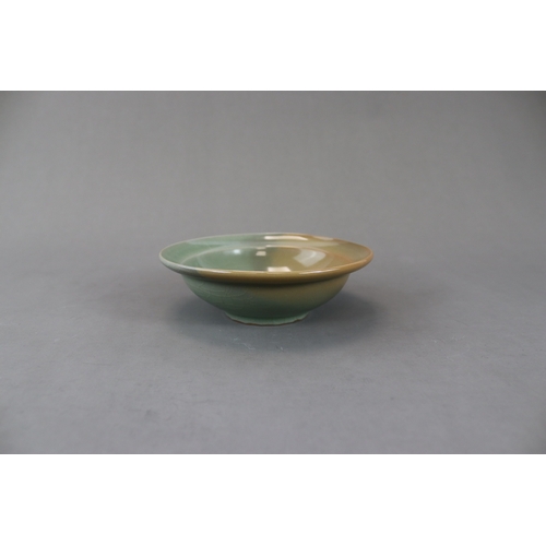 230 - A Longquan Celadon Dish, Song dynasty the rounded sides rising from a short straight foot to an ever... 