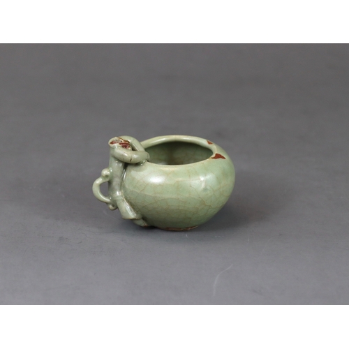 48 - A Rare Longquan Celadon Waterpot, Yuan dynasty finely potted with a figure climbing at the edge of t... 