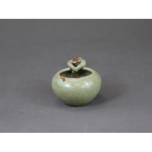 48 - A Rare Longquan Celadon Waterpot, Yuan dynasty finely potted with a figure climbing at the edge of t... 