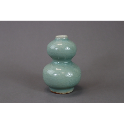 53 - A Longquan Celadon Double-gourd Vase, Song/Yuan dynasty the compressed globular lower bulb rising fr... 