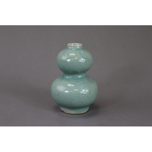 53 - A Longquan Celadon Double-gourd Vase, Song/Yuan dynasty the compressed globular lower bulb rising fr... 