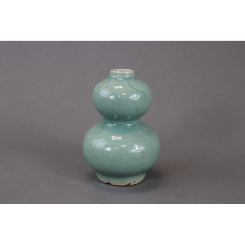 53 - A Longquan Celadon Double-gourd Vase, Song/Yuan dynasty the compressed globular lower bulb rising fr... 